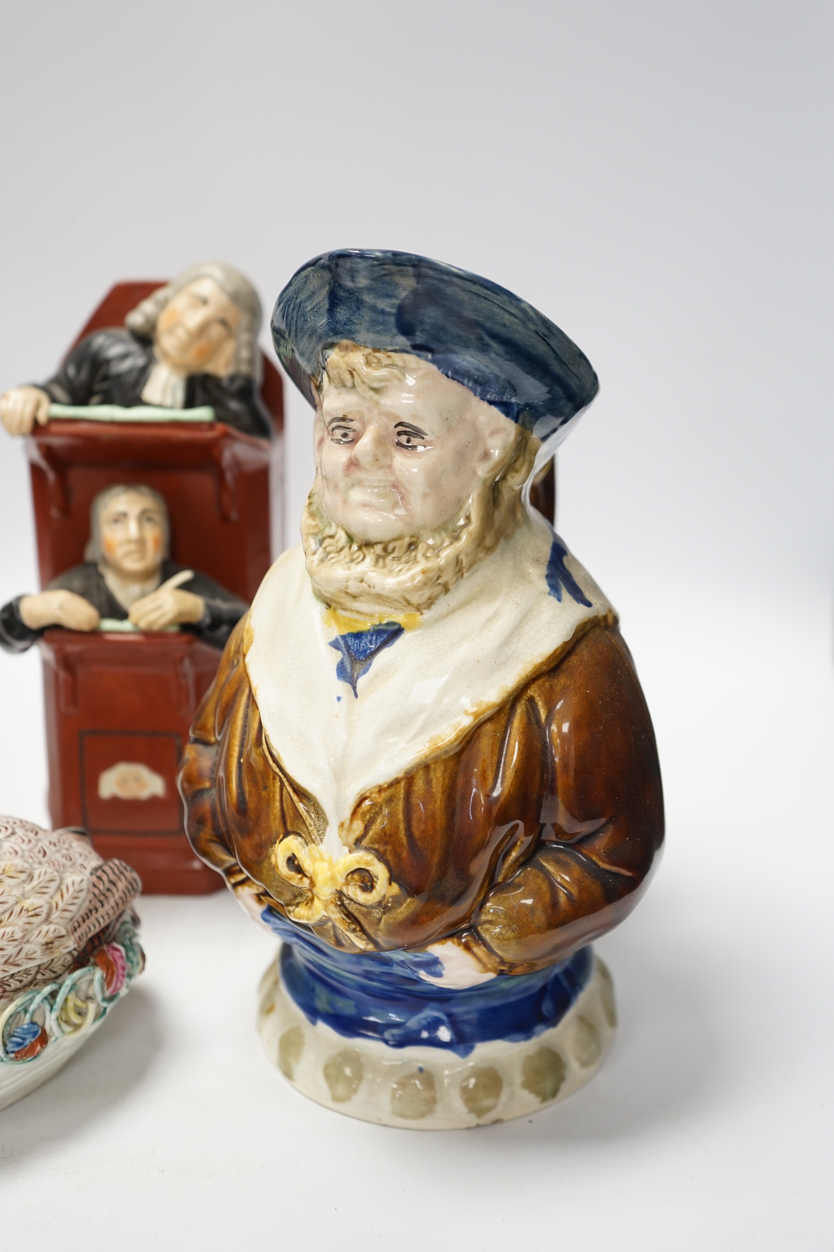 A Staffordshire figure of Wellington, a majolica sailor jug and a Vicar and Moses group, largest 32cm high